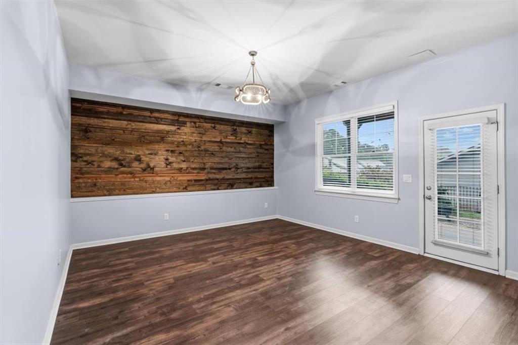 201 Providence Lane Canton, GA 30114 - Photo 28 of 50 a view of an empty room with wooden floor and a window