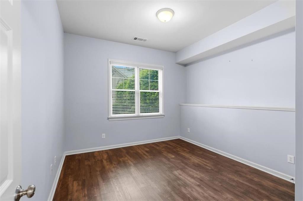 201 Providence Lane Canton, GA 30114 - Photo 29 of 50 an empty room with wooden floor and windows