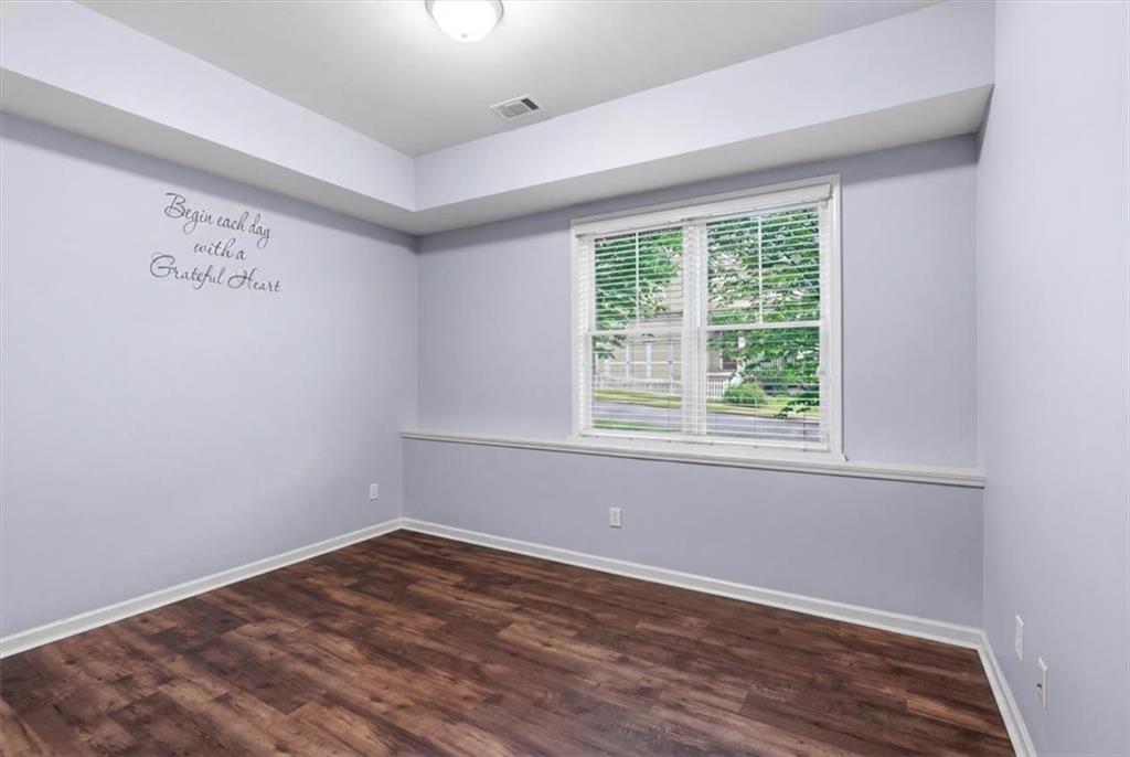 201 Providence Lane Canton, GA 30114 - Photo 30 of 50 an empty room with wooden floor and windows