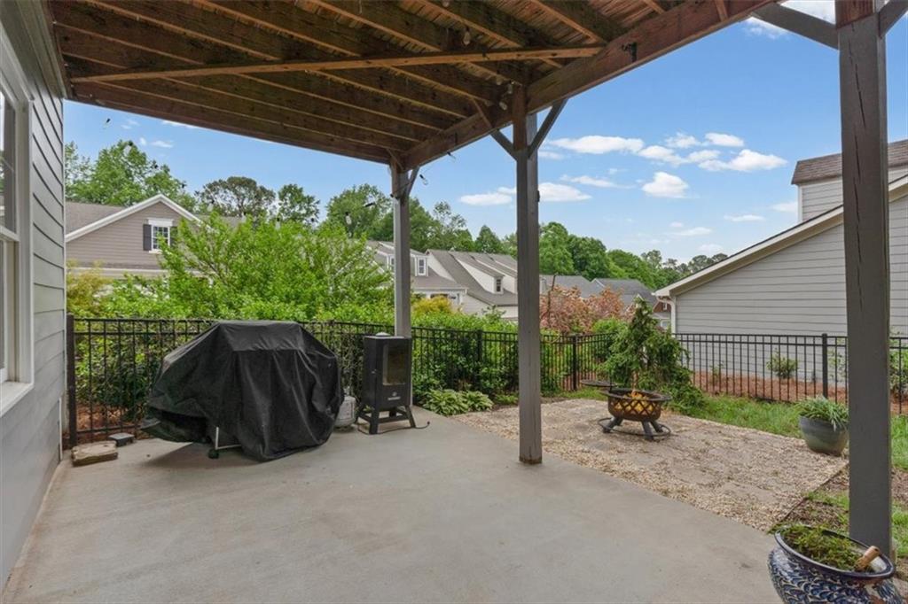 201 Providence Lane Canton, GA 30114 - Photo 32 of 50 a backyard of a house with table and chairs under an umbrella