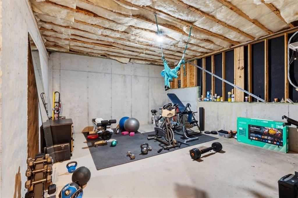 201 Providence Lane Canton, GA 30114 - Photo 37 of 50 a storage room with lots of clutter and bicycles