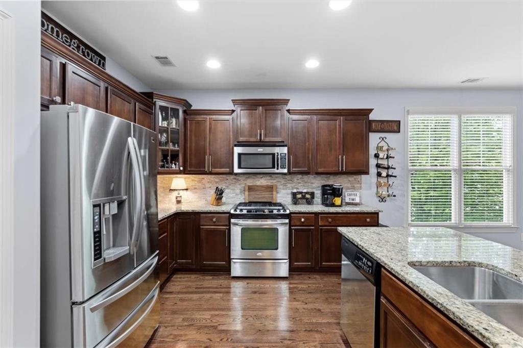 201 Providence Lane Canton, GA 30114 - Photo 10 of 50 a kitchen with stainless steel appliances granite countertop a refrigerator stove and sink
