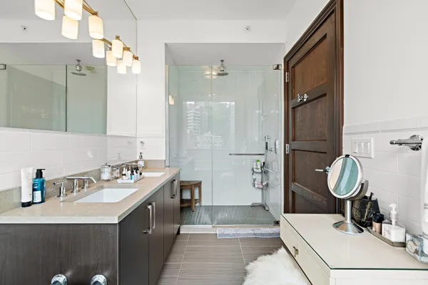 a bathroom with a sink double vanity and a mirror