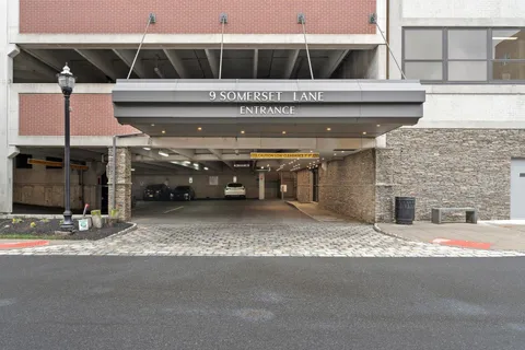a living room with furniture and a mirror