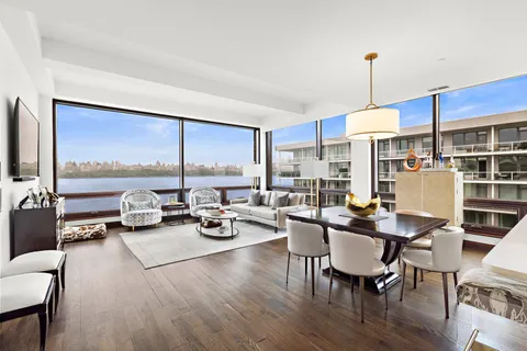 a view of a dining room with furniture a chandelier and wooden floor