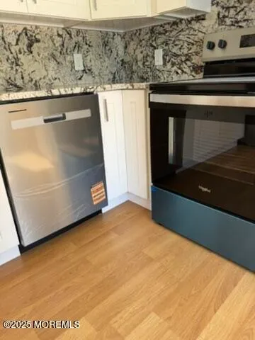 a kitchen with stainless steel appliances kitchen island granite countertop a refrigerator and a sink