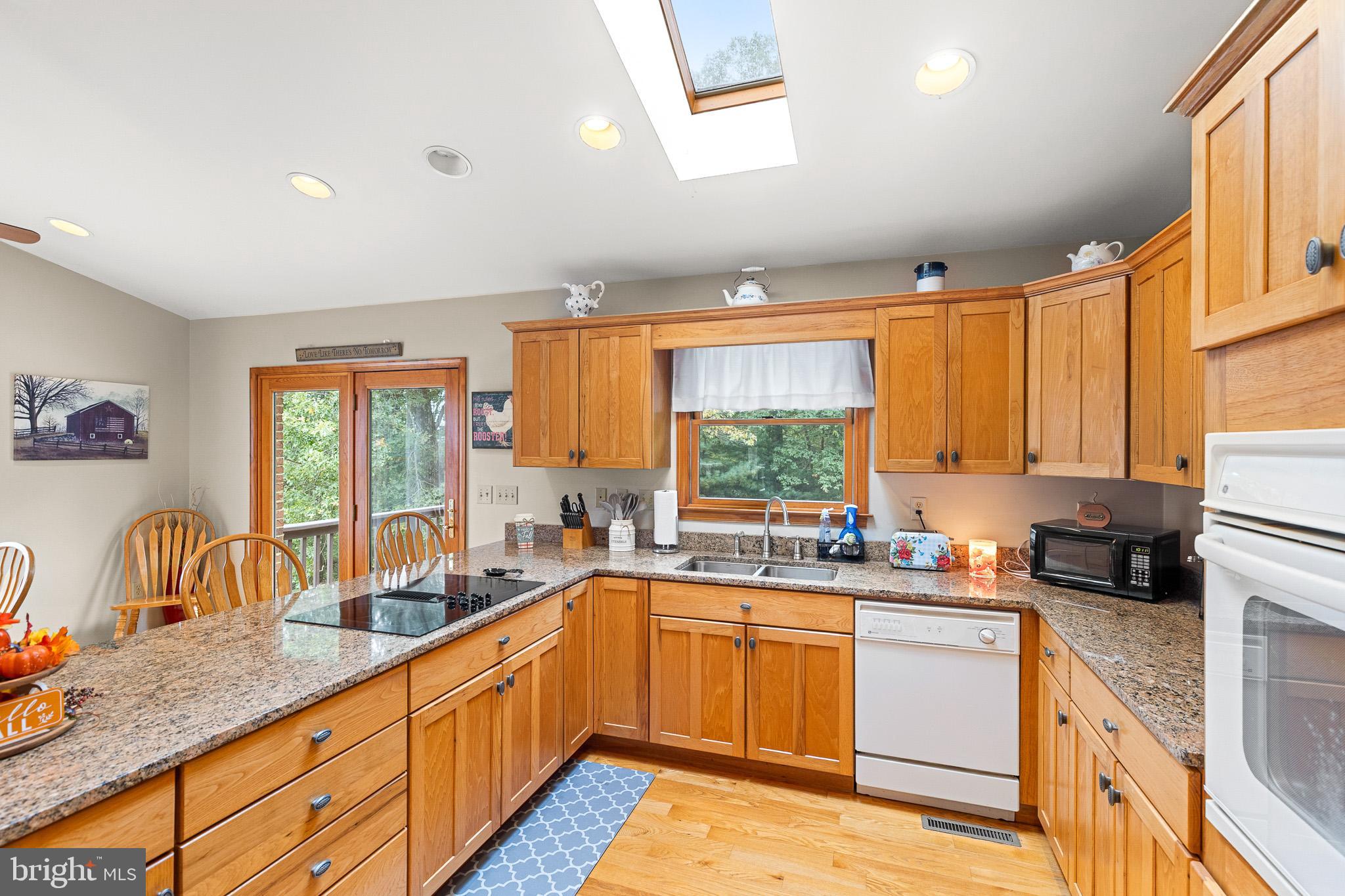 21246 Clarks Mountain Road Rapidan, VA 22733 - Photo 15 of 38 a kitchen with a sink stove and cabinets