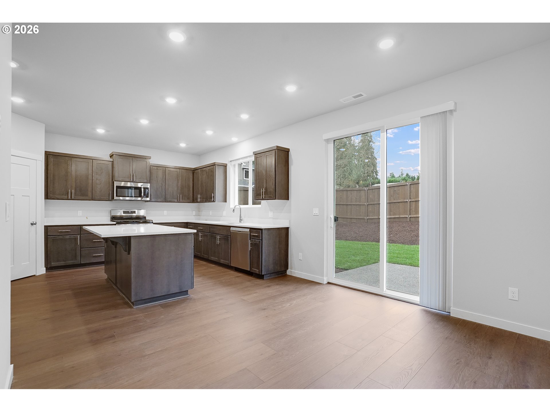 33374 Southwest Rokin Way Scappoose, OR 97056 - Photo 38 of 44 a large kitchen with a large counter top a sink stainless steel appliances and cabinets