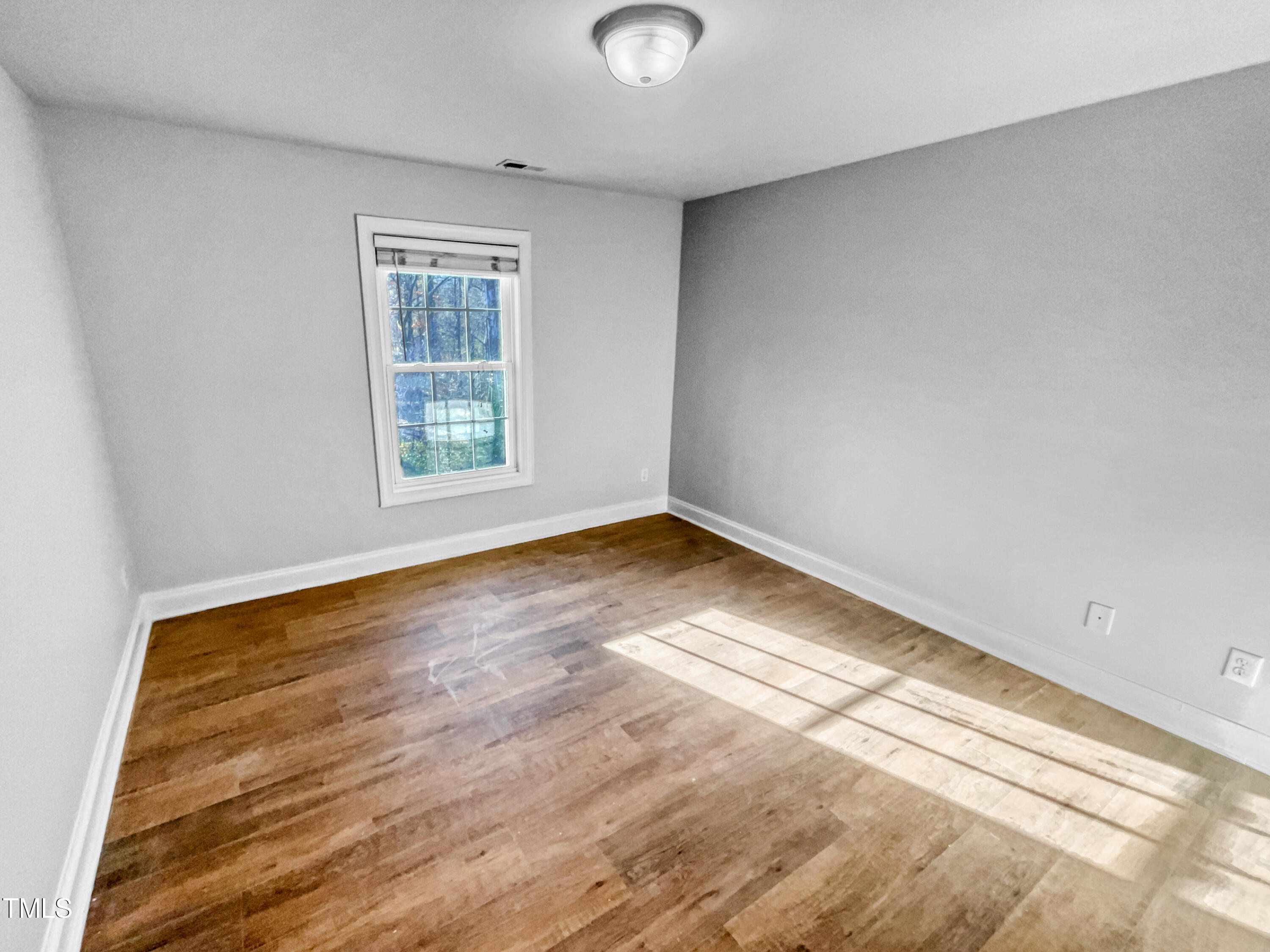421 Cottesbrook Drive Wake Forest, NC 27587 - Photo 14 of 19 an empty room with wooden floor and windows