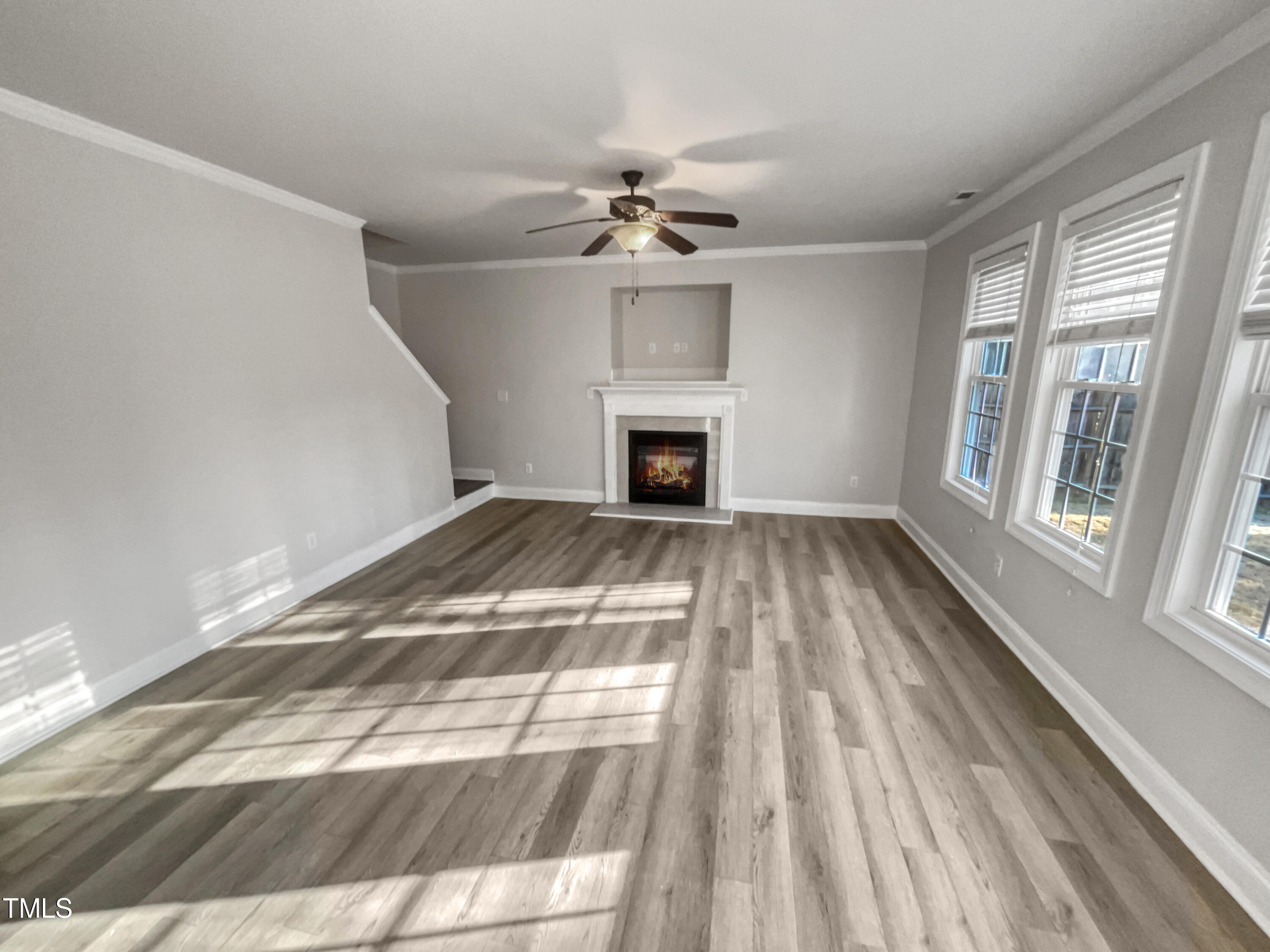 421 Cottesbrook Drive Wake Forest, NC 27587 - Photo 3 of 19 a view of an empty room with chandelier fan and wooden floor