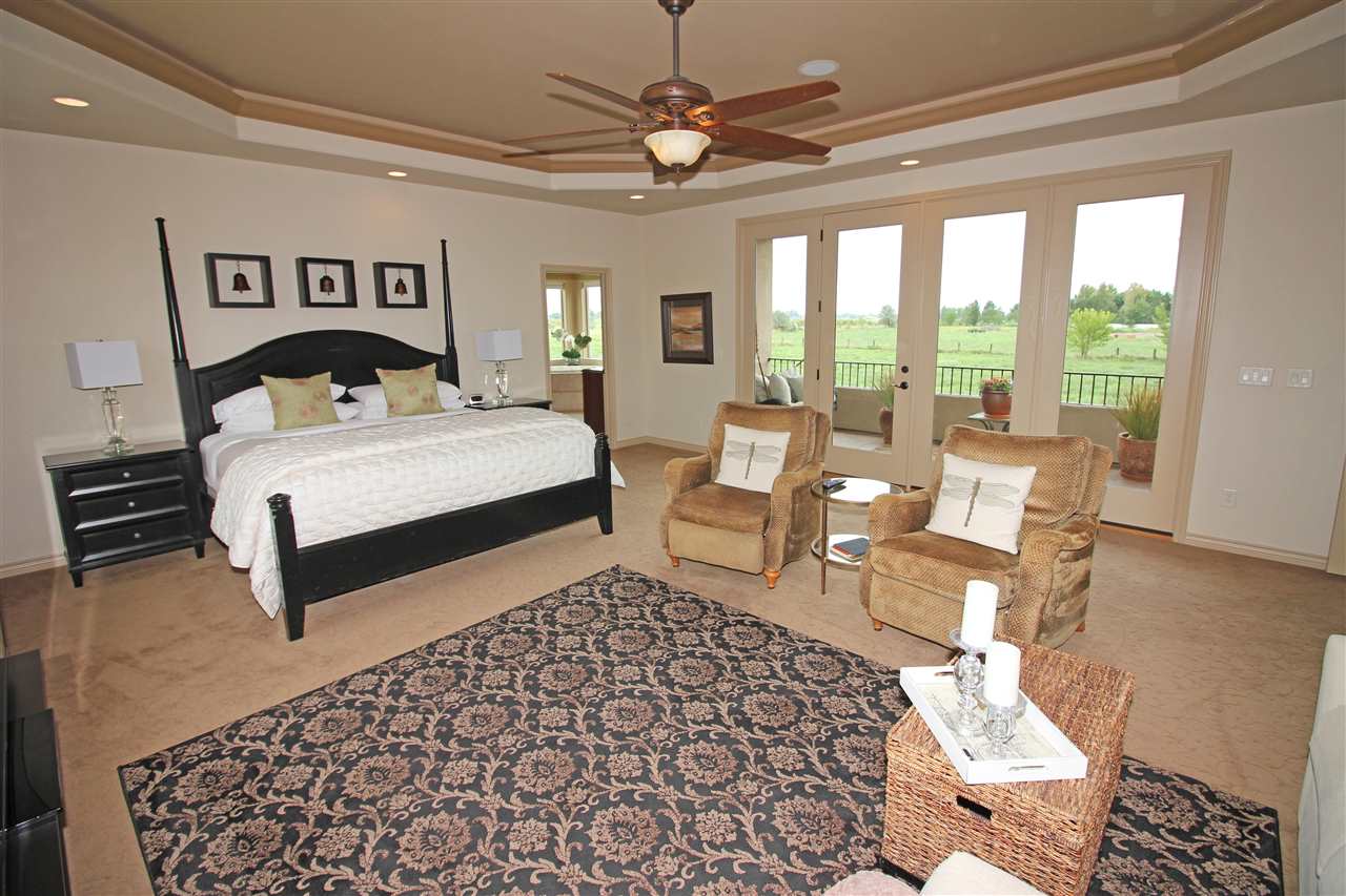 1116 22 Road Grand Junction, CO 81505 - Photo 20 of 42 a bedroom with a bed and a chandelier