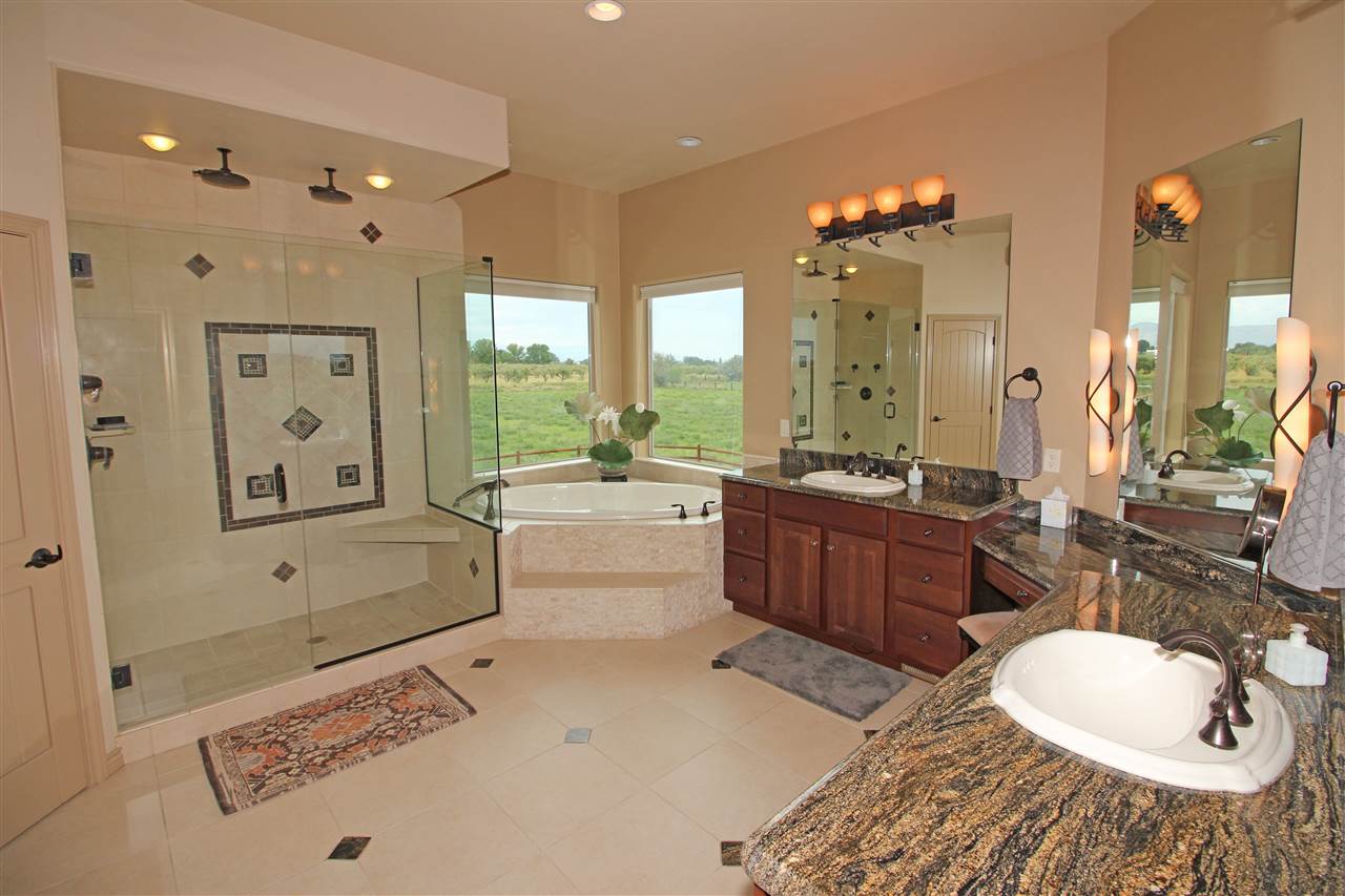 1116 22 Road Grand Junction, CO 81505 - Photo 22 of 42 a spacious bathroom with a tub sink and mirror