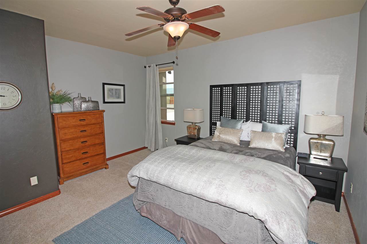 1116 22 Road Grand Junction, CO 81505 - Photo 28 of 42 a bedroom with a bed and a dresser