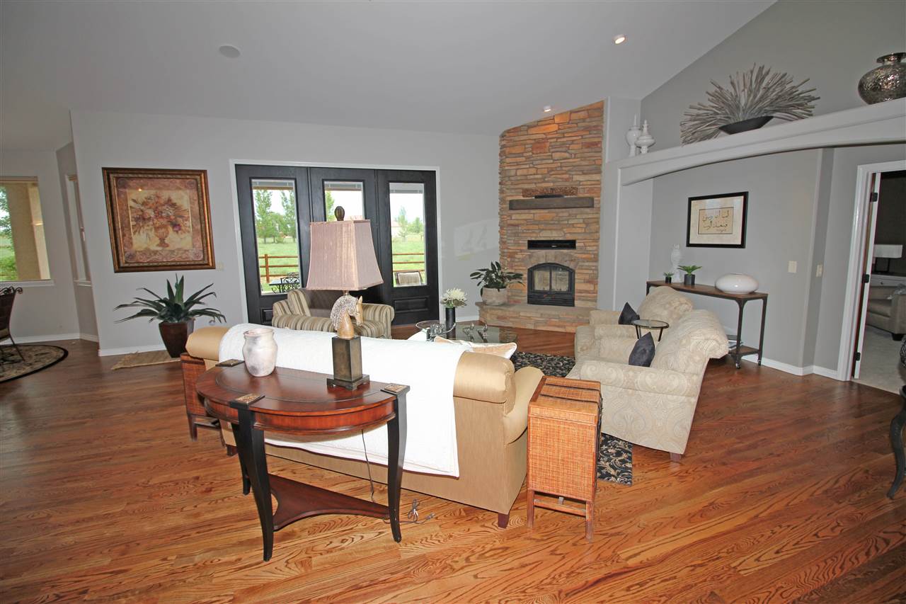 1116 22 Road Grand Junction, CO 81505 - Photo 4 of 42 a living room with furniture a table and wooden floor