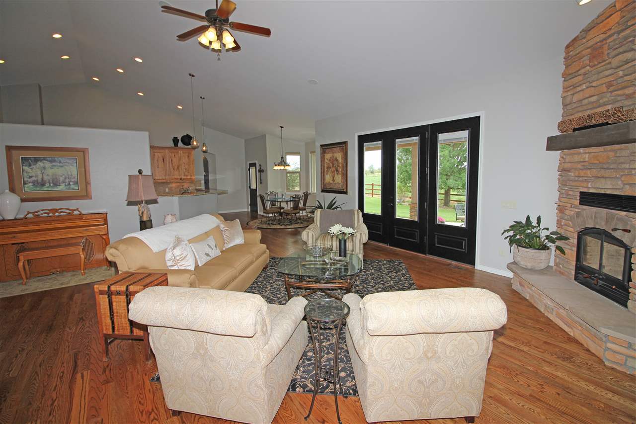 1116 22 Road Grand Junction, CO 81505 - Photo 5 of 42 a living room with furniture a fireplace and a dining table with wooden floor