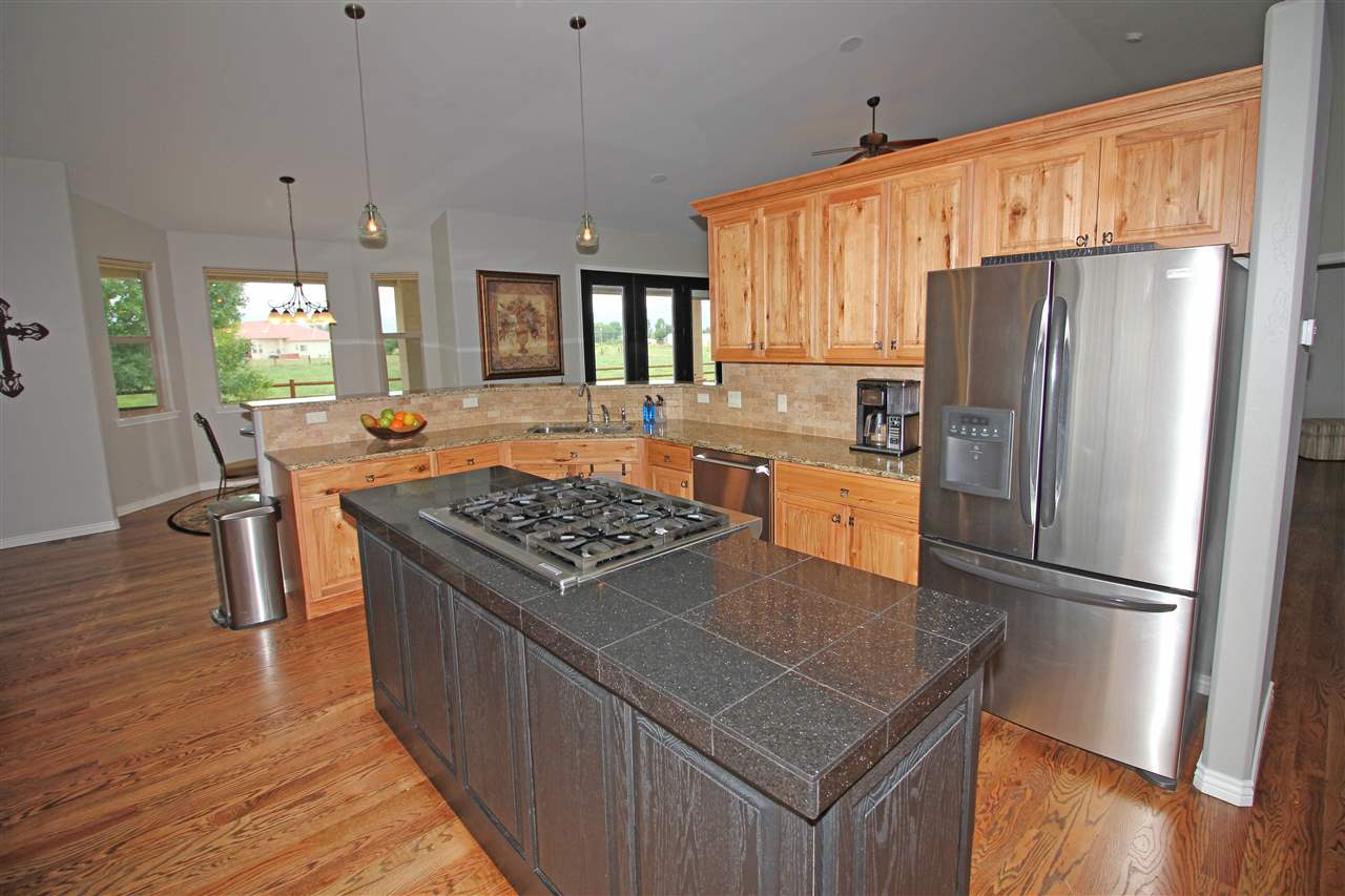 1116 22 Road Grand Junction, CO 81505 - Photo 9 of 42 a kitchen with kitchen island a counter top space a sink stainless steel appliances and cabinets