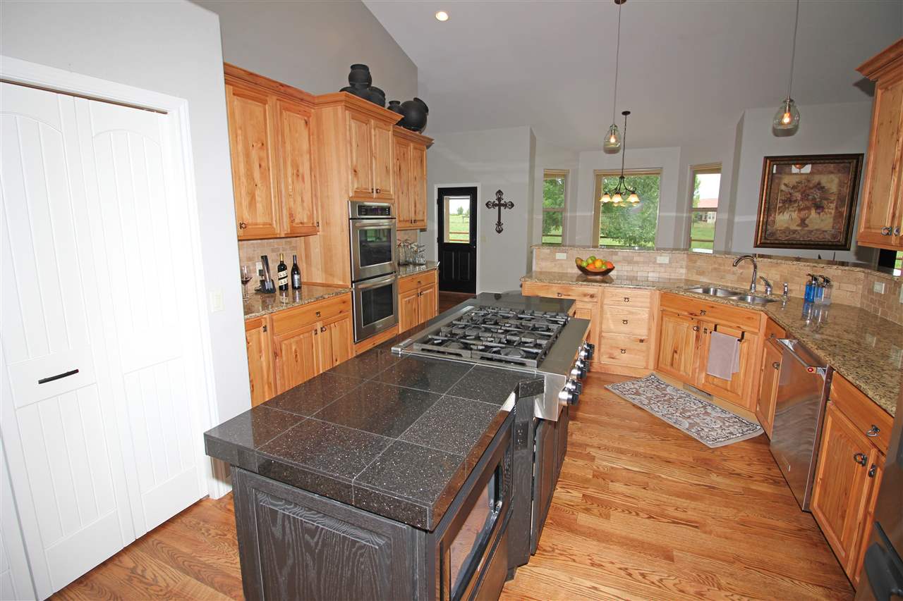 1116 22 Road Grand Junction, CO 81505 - Photo 10 of 42 a kitchen with stainless steel appliances granite countertop a stove a sink dishwasher and a refrigerator