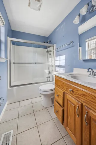 a bathroom with a sink a toilet and a shower