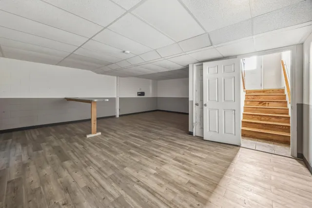 a view of room with wooden floor and windows