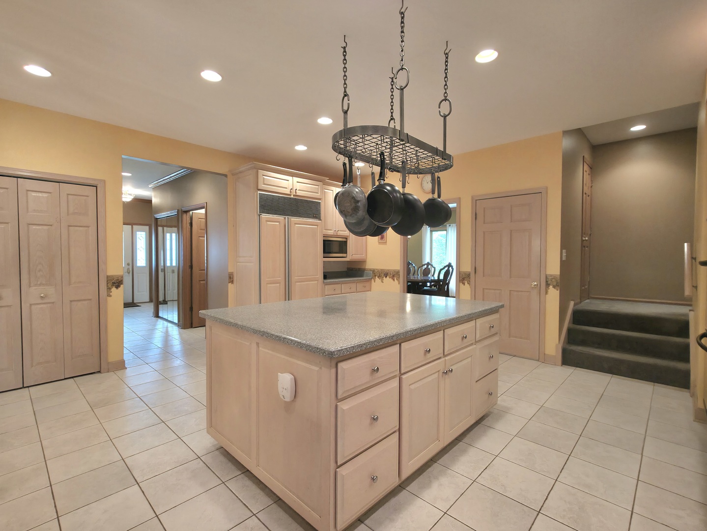 10160 Lancaster Drive Mokena, IL 60448 - Photo 6 of 41 a kitchen with stainless steel appliances granite countertop a refrigerator a sink dishwasher and white cabinets with wooden floor