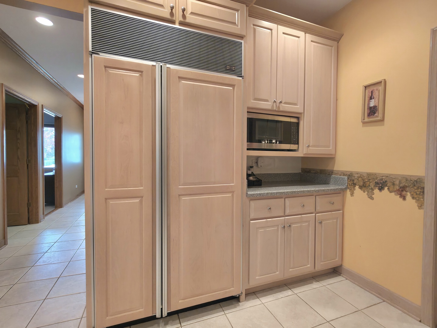 10160 Lancaster Drive Mokena, IL 60448 - Photo 7 of 41 a kitchen with granite countertop white cabinets and refrigerator