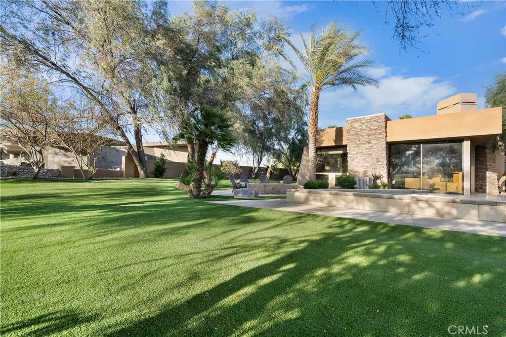 68 Royal St Georges Way Rancho Mirage, CA 92270 - Photo 13 of 75 a view of a fountain in front of a house with a big yard