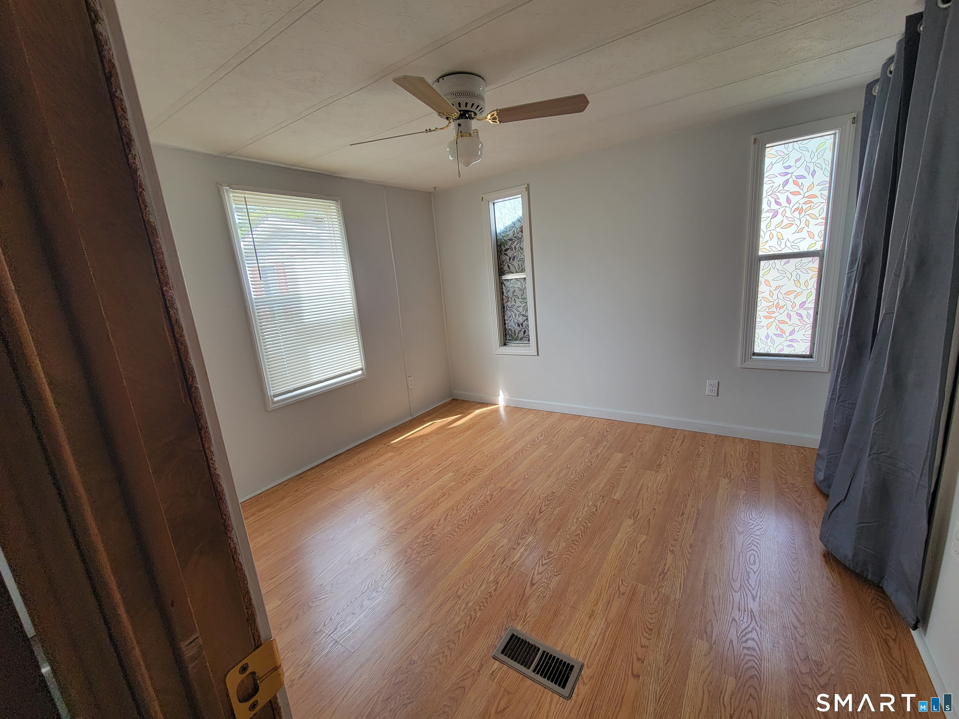 1290 N Road Groton, CT 06340 - Photo 7 of 11 wooden floor in an empty room with a window