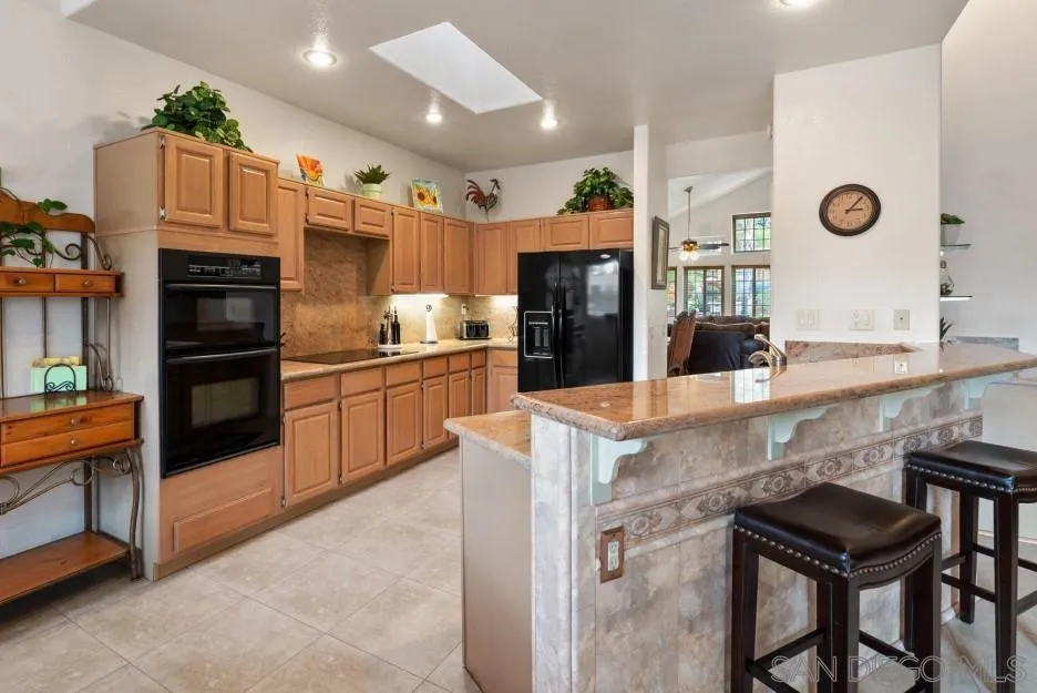 14420 Silver Heights Road Poway, CA 92064 - Photo 34 of 73 a kitchen with stainless steel appliances granite countertop a sink and a refrigerator