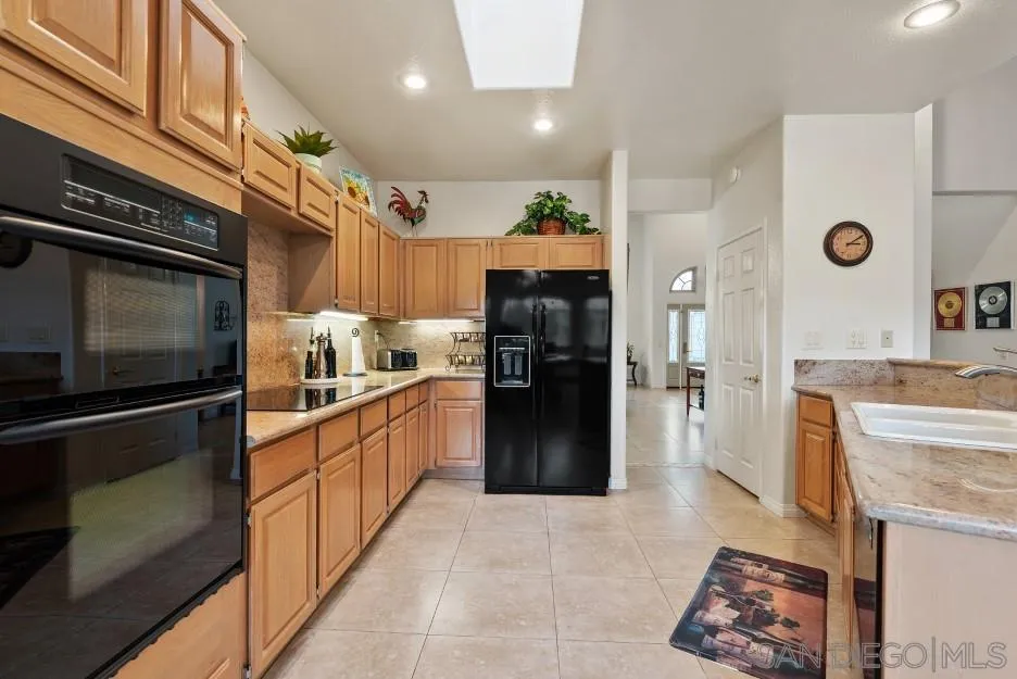 14420 Silver Heights Road Poway, CA 92064 - Photo 38 of 73 a kitchen with a refrigerator and a stove