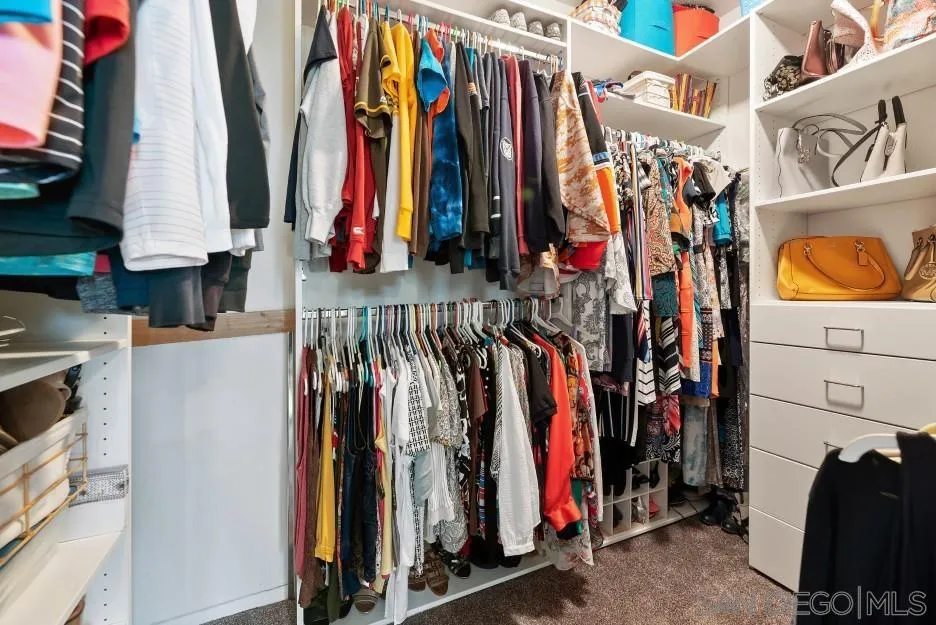 14420 Silver Heights Road Poway, CA 92064 - Photo 50 of 73 a view of walk in closet with clothes