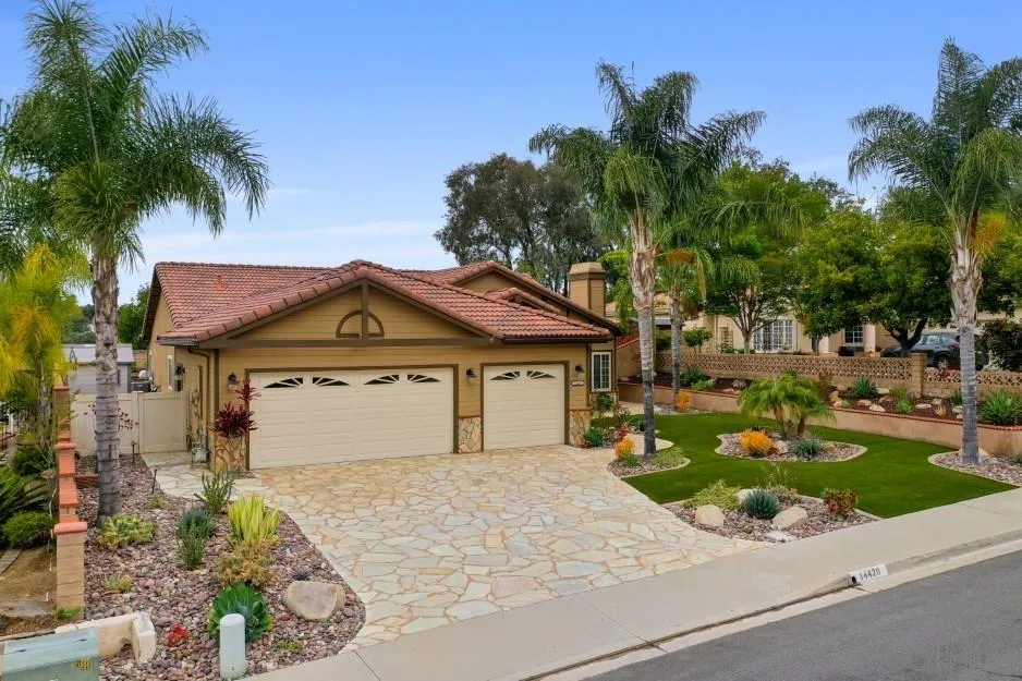 14420 Silver Heights Road Poway, CA 92064 - Photo 5 of 73 a front view of a house with a garden and trees