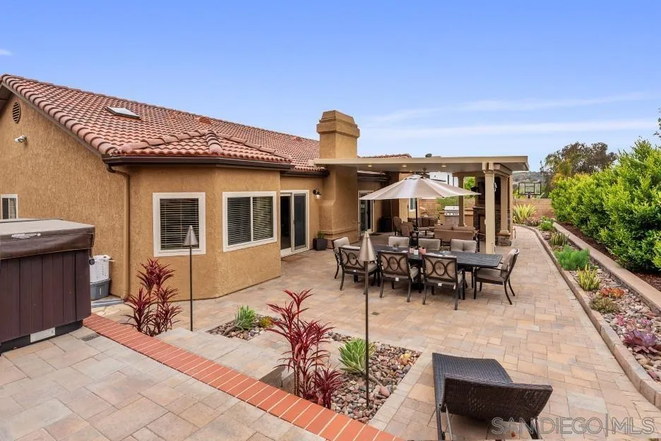 14420 Silver Heights Road Poway, CA 92064 - Photo 71 of 73 a view of a patio with table and chairs potted plants with wooden fence
