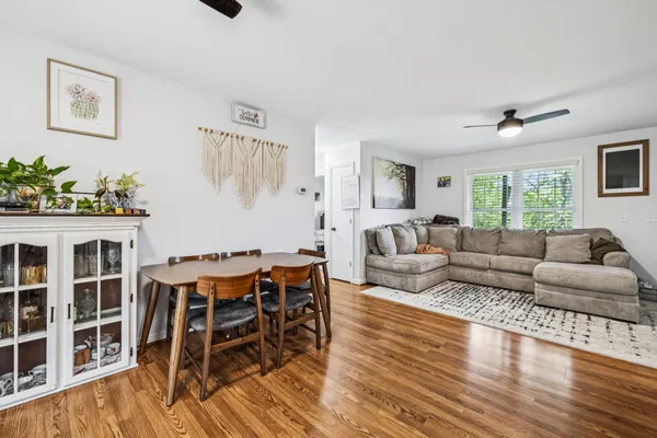 a living room with furniture wooden floor and a window
