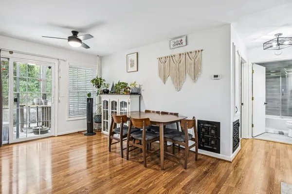 a bedroom with a bed dresser and a large window