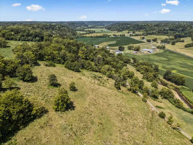 an aerial view of a house with a yard and lake view