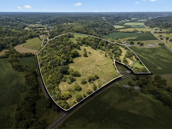 a kitchen with stainless steel appliances granite countertop a stove top oven a sink dishwasher and a microwave oven with white cabinets