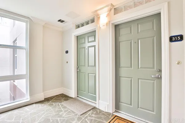 a view of a dining room with furniture and a entryway