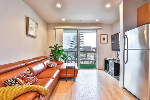 a living room with furniture and a potted plant