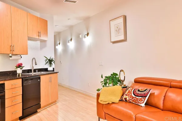 a outdoor kitchen with stainless steel appliances furniture refrigerator and a window