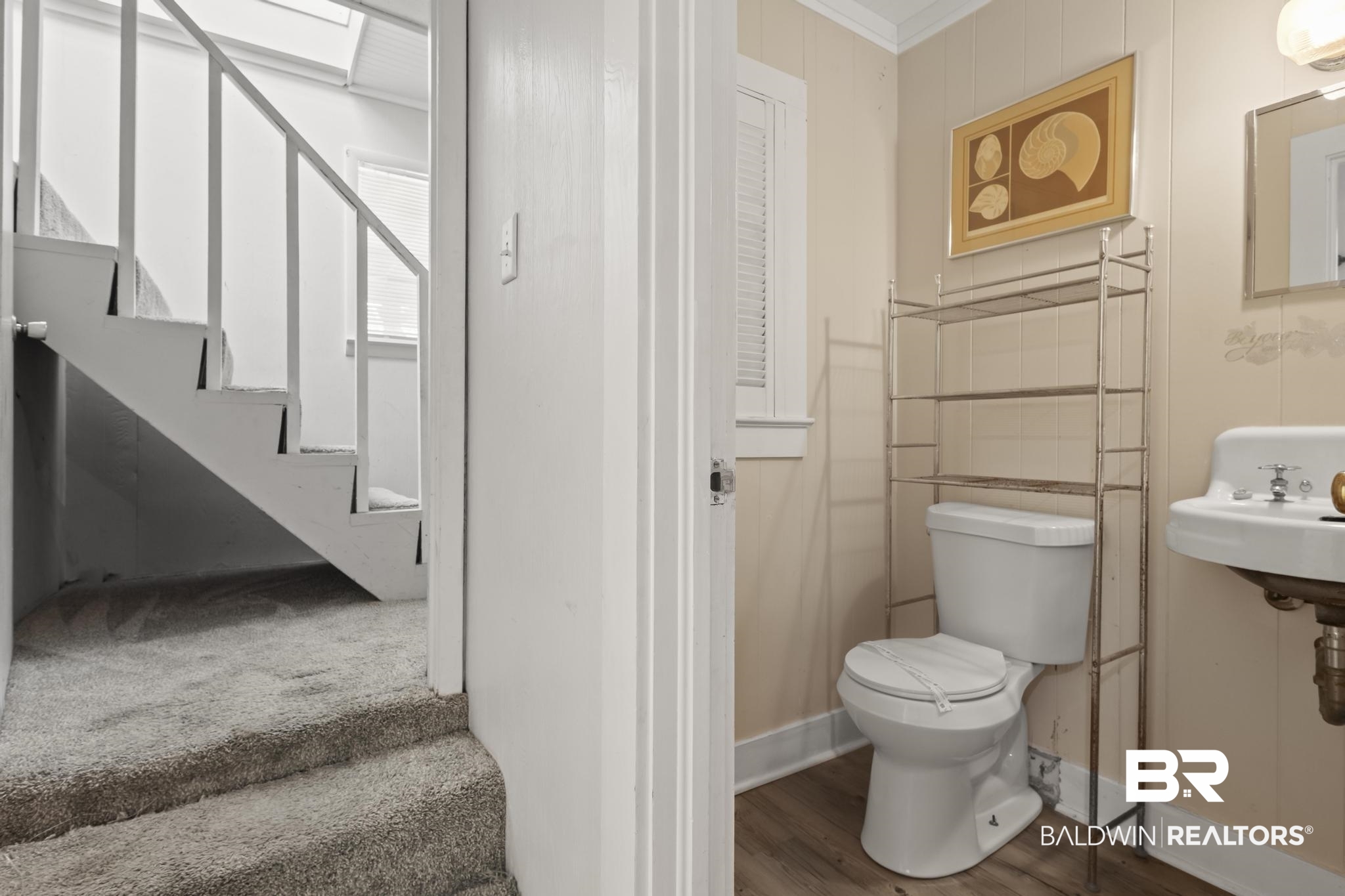 562 Veterans Road Gulf Shores, AL 36542 - Photo 19 of 32 Half bathroom with toilet, wood finished floors, crown molding, and baseboards