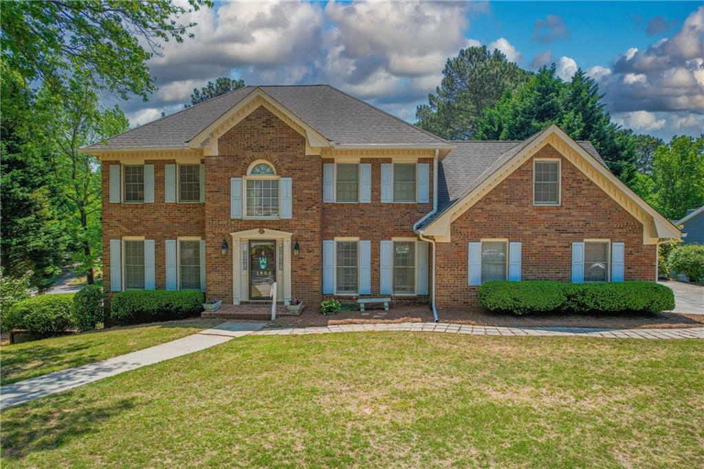 1495 Maple Ridge Drive Suwanee, GA 30024 - Photo 1 of 1 a front view of a house with garden