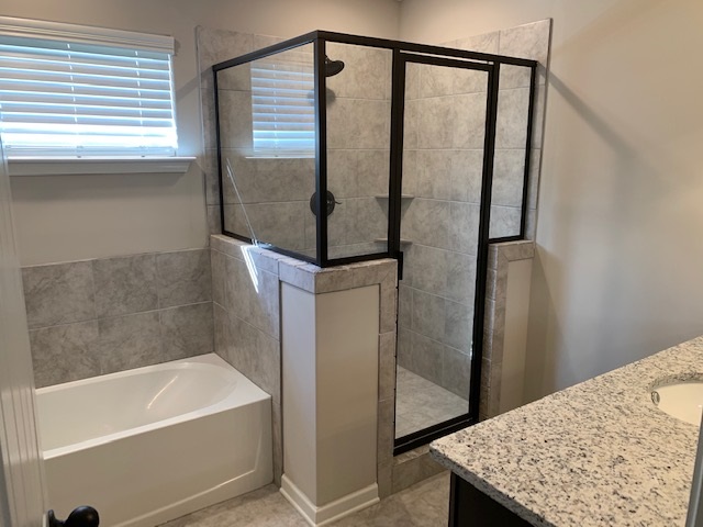 1065 Carib Loop East Cordova, TN 38018 - Photo 6 of 16 a bathroom with a bathtub and a shower