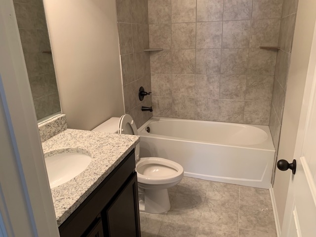 1065 Carib Loop East Cordova, TN 38018 - Photo 9 of 16 a bathroom with a granite countertop toilet sink and bathtub