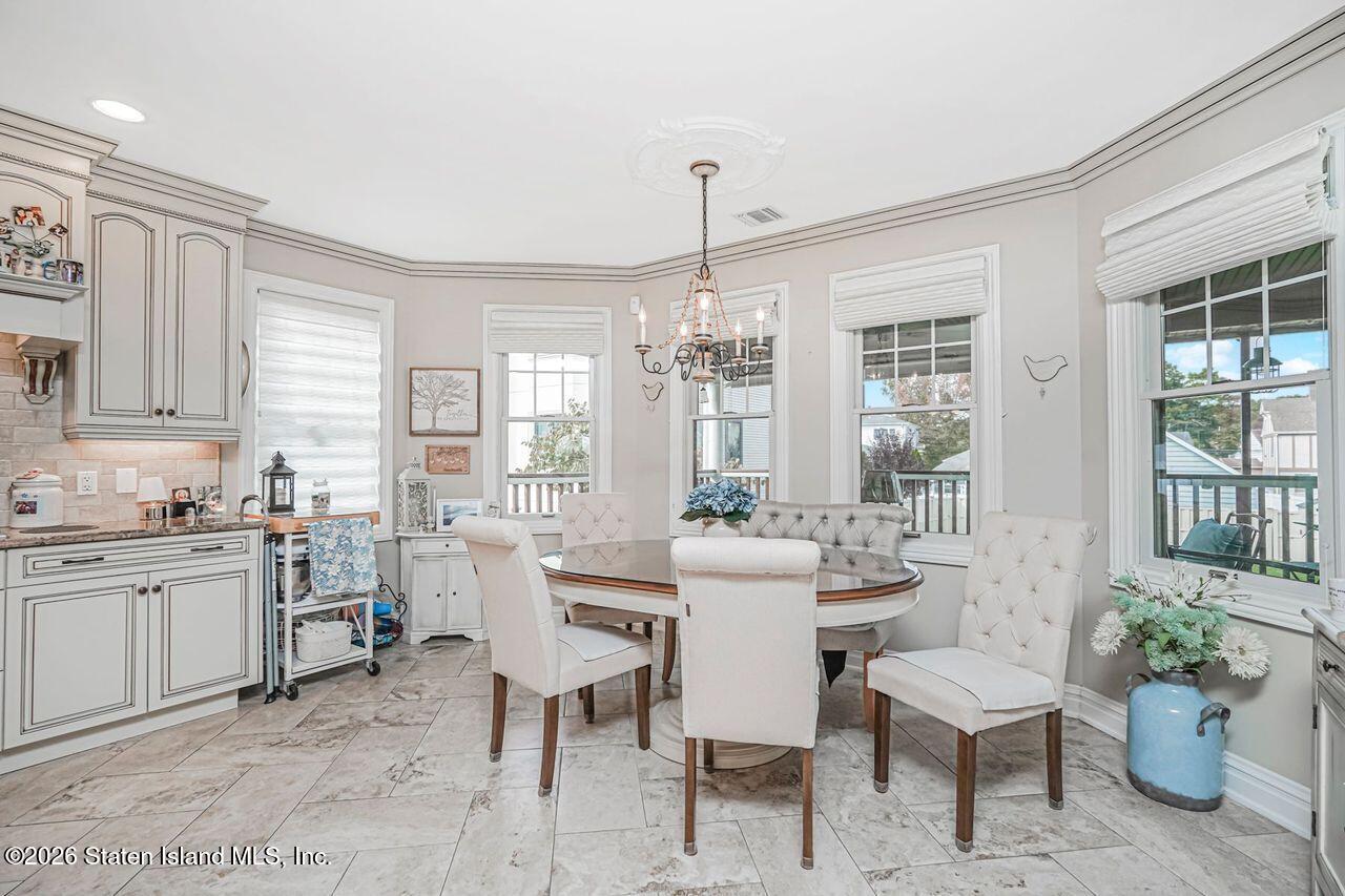 63 Finlay Avenue Staten Island, NY 10309 - Photo 16 of 44 a view of a dining room with furniture window and wooden floor