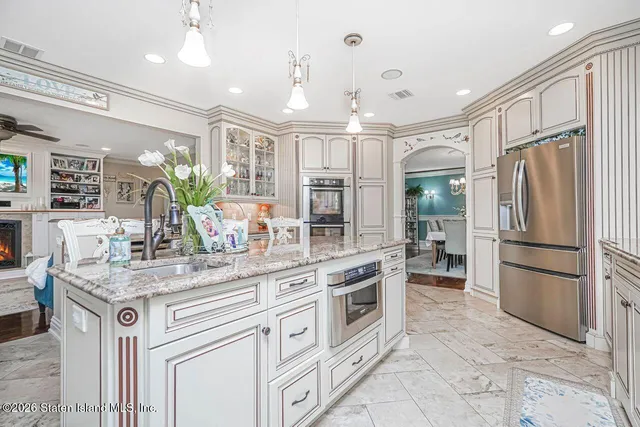 a dining room with furniture a large window and kitchen view
