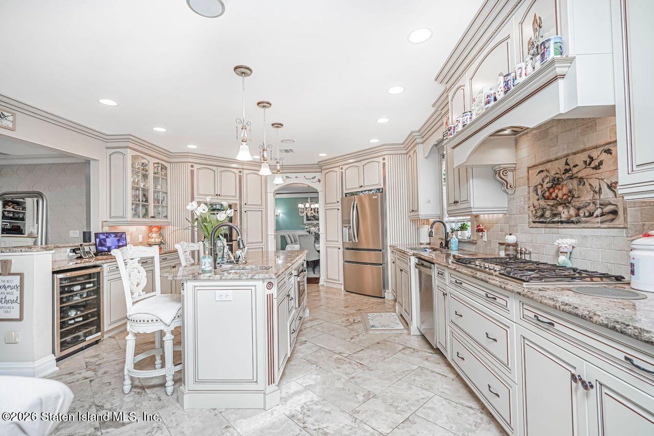 63 Finlay Avenue Staten Island, NY 10309 - Photo 19 of 44 a kitchen with stainless steel appliances kitchen island granite countertop a stove refrigerator and cabinets