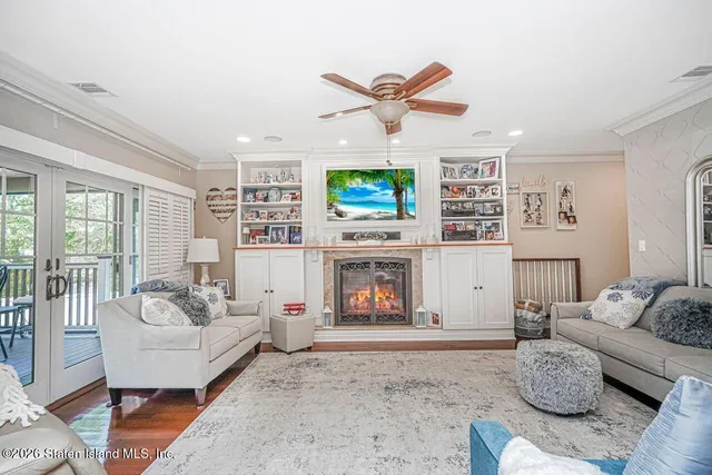 a living room with furniture tv and a large window