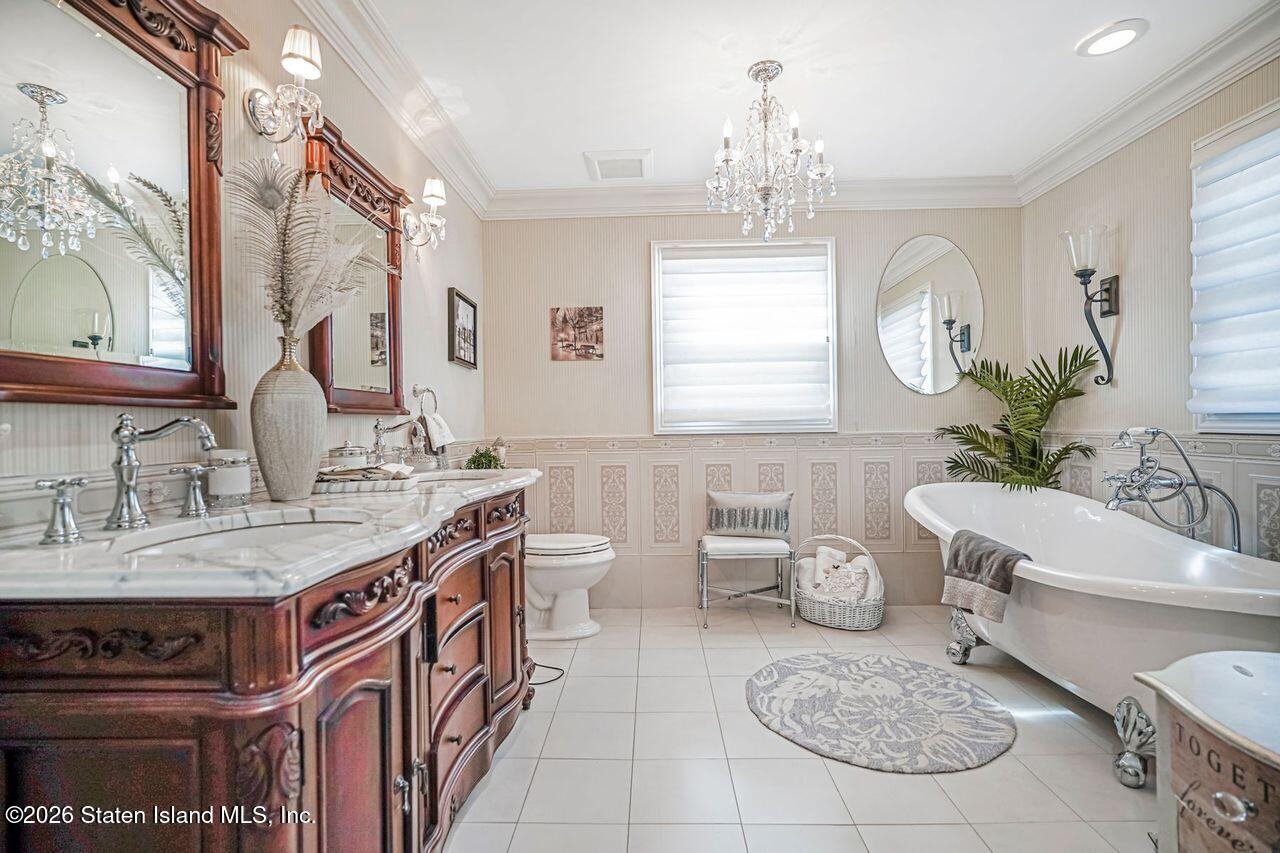 63 Finlay Avenue Staten Island, NY 10309 - Photo 28 of 44 a spacious bathroom with a granite countertop sink and a mirror