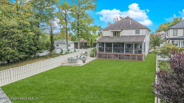 a front view of a house with a yard table and chairs