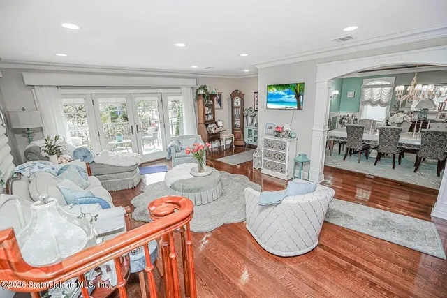 a living room with lots of furniture and a wooden floor